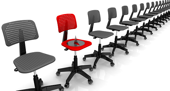 Empty black office chairs on a white surface lined up in row and large and sharp thumbtack lying on one red office chair. Isolated. 3D Illustration