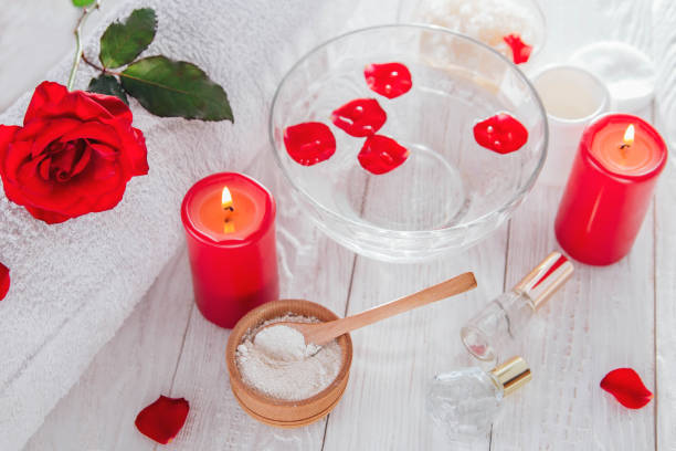 istock Spa essentials including candle, salt, roses and white clay 826500580
