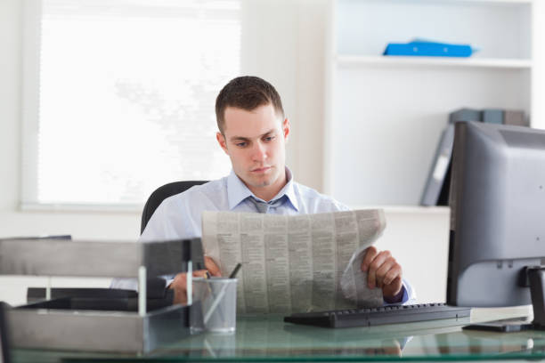 istock Businessman reading the newspaper 826511546