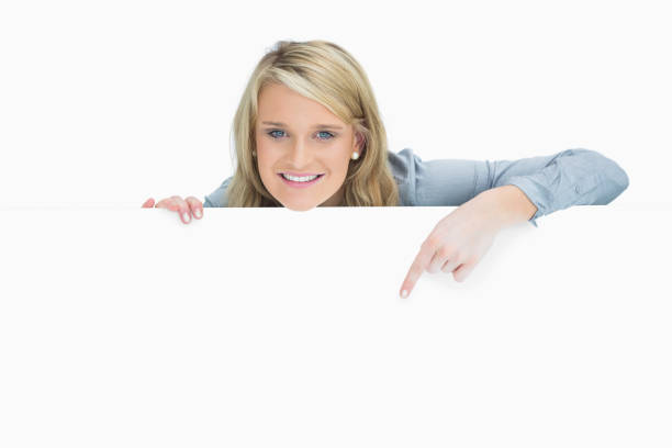 istock Cheerful woman pointing down 826511884