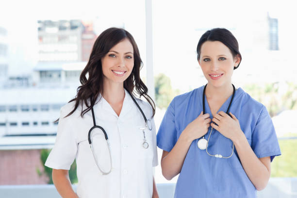 istock Medical interns standing upright in their short sleeve uniforms 826512048