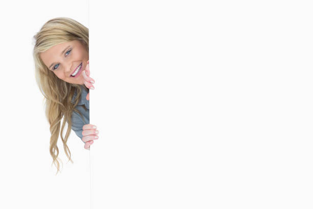 istock Blueeyed woman hiding behind a poster 826512304
