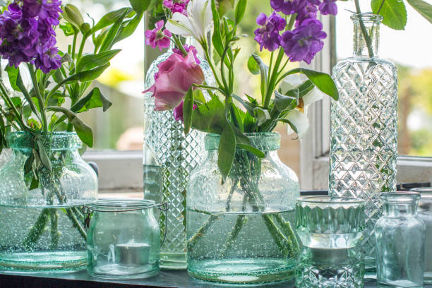 istock Jars of flowers on windowsill 826519548