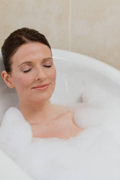 istock Beautiful woman taking a bath 826520124