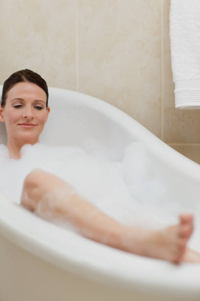 istock Beautiful woman taking a bath 826520442