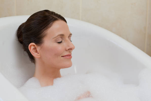 istock Beautiful woman taking a bath 826520560