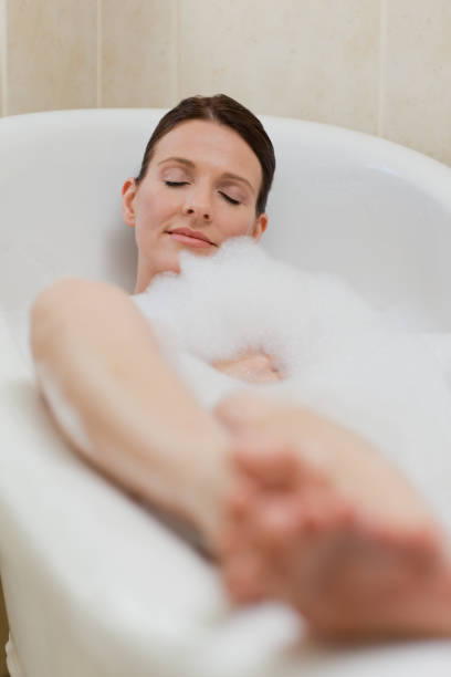istock Beautiful woman taking a bath 826520586
