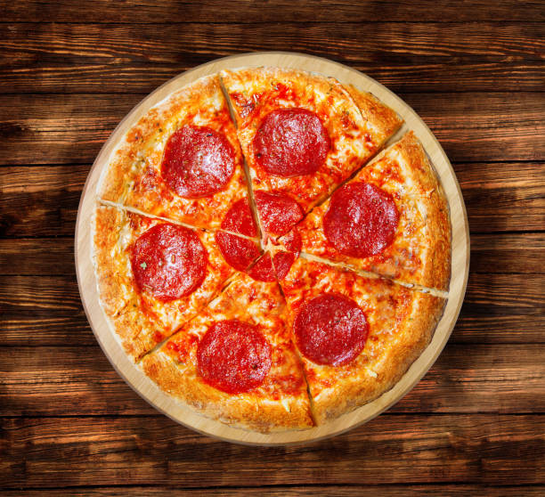 istock Pizza salami on the  wooden table. 826520596