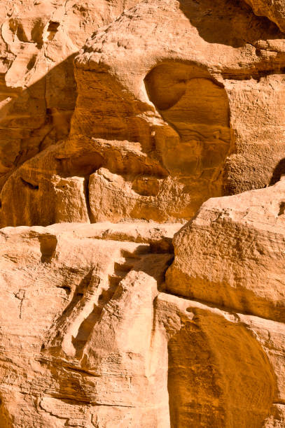 Close-up of intricate sandstone swirls and erosion patterns, highlighting the natural beauty and texture of sedimentary rock formations. Perfect for geological themes and backgrounds.
