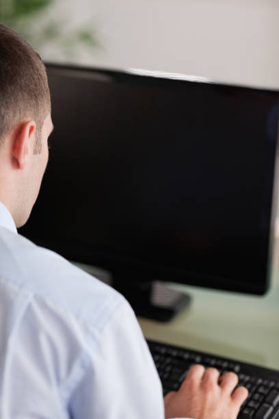 istock Close up of businessmans back working on his computer 826541560