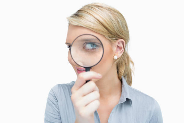 istock Businesswoman looking through magnifying glass 826544506