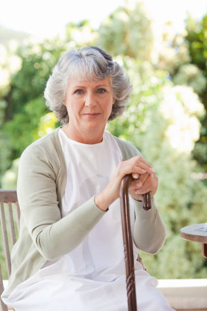 istock Retired woman with her walking stick 826548774