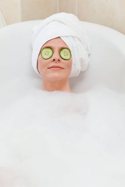 istock Relaxed woman taking a bath with a towel on her head 826551344
