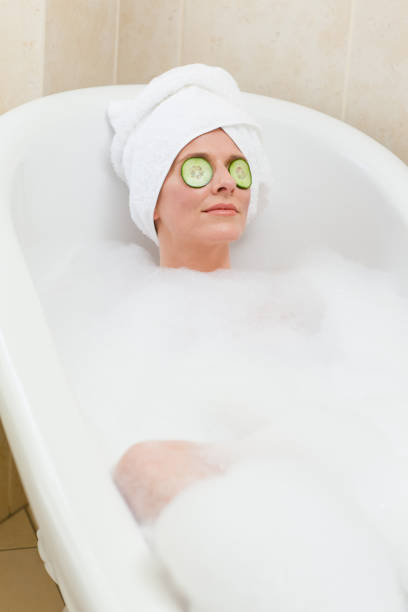 istock Relaxed woman taking a bath with a towel on her head 826551386