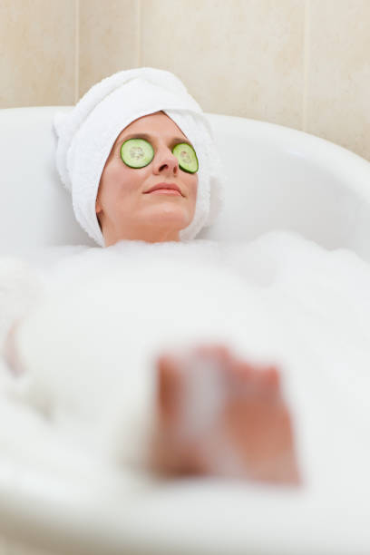 istock Relaxed woman taking a bath with a towel on her head 826551438