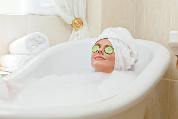 istock Relaxed woman taking a bath with a towel on her head 826551512