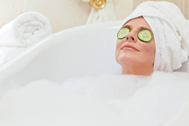 istock Relaxed woman taking a bath with a towel on her head 826551574