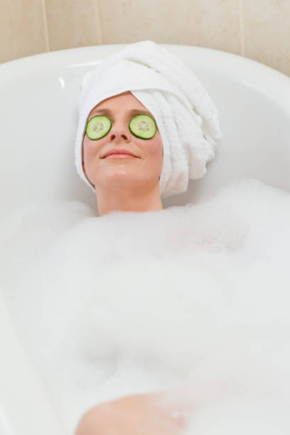 istock Relaxed woman taking a bath with a towel on her head 826551648