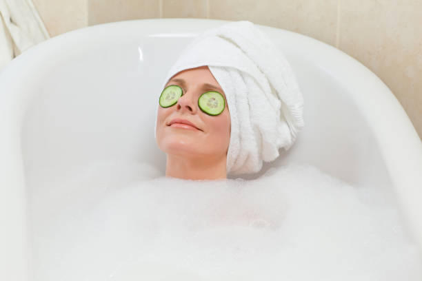 istock Relaxed woman taking a bath with a towel on her head 826551690