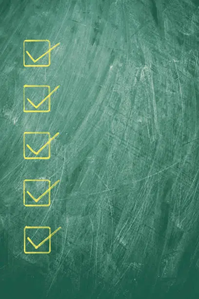 Photo of Checklist on blackboard background textured