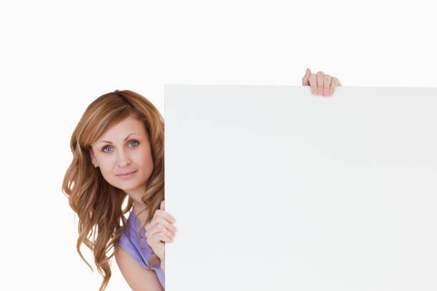 istock Cute blondhaired woman holding a white board 826561274