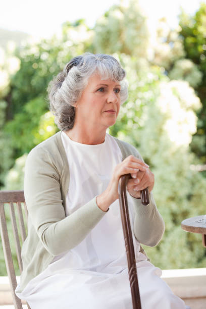 istock Retired woman with her walking stick 826574932