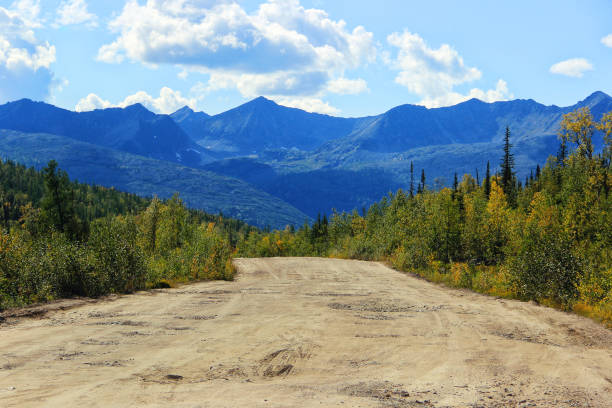 istock Dirt road and mountains in Siberia 826575250