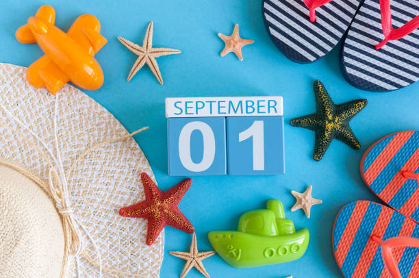 istock 1st September. Image of september 1, calendar on blue summer background with beach vacation accessories. Back to school concept 826580982