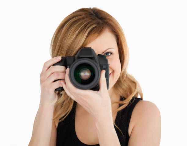 istock Blondhaired woman taking a photo with a camera 826582170