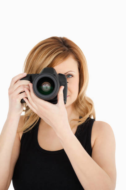 istock Attractive blondhaired woman taking a photo with a camera 826582244