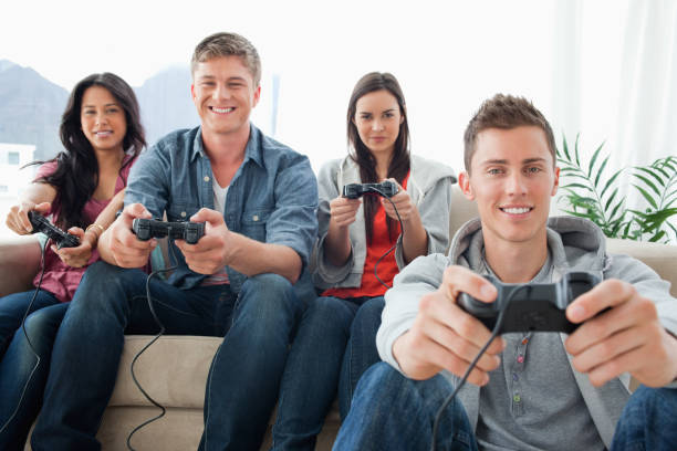 istock A happy group of friends playing games together while looking at the camera 826584628