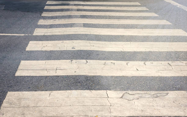 istock Old white zebra crossing lines on the road. 826594012