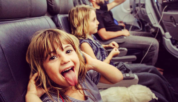 Wild passenger Little kid makes funny faces on an airplane plane hand tool stock pictures, royalty-free photos & images