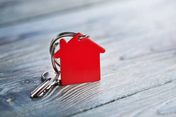 istock Real estate concept, Key ring and keys on wooden background 826594752