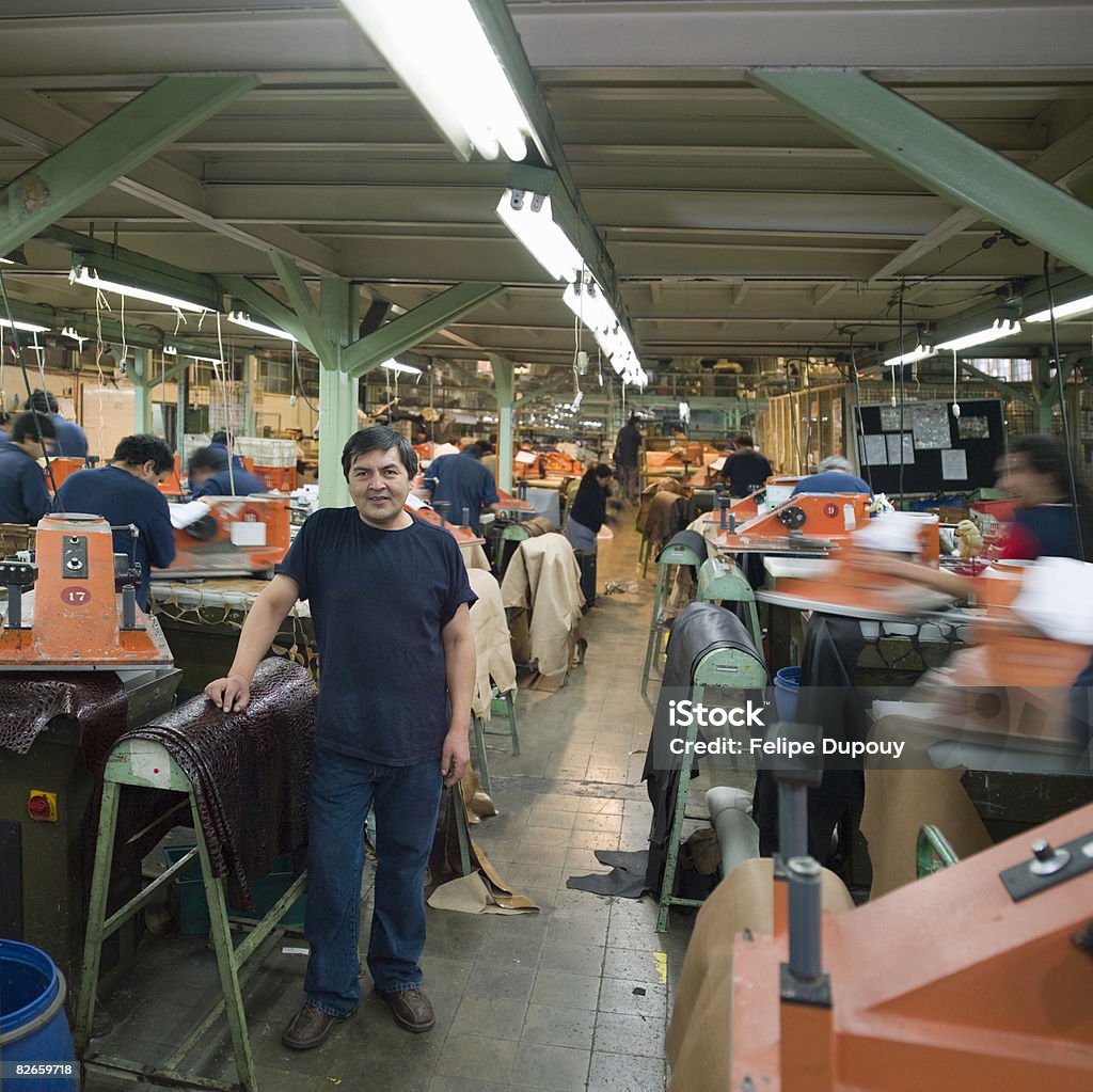 Portrait of a man amongst co-workers in a factory  Chile Stock Photo