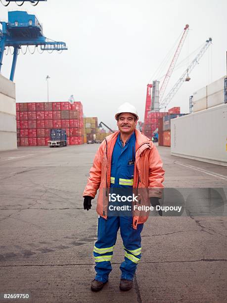 Portrait Of A Man Working In A Shipping Yard Stock Photo - Download Image Now - Commercial Dock, Crane - Machinery, One Person