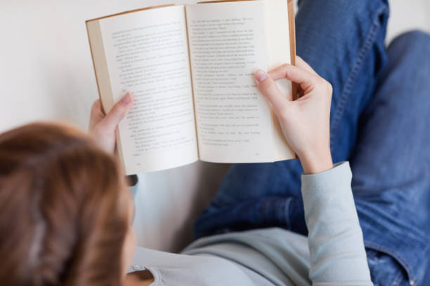 istock Shadowing woman reading on the sofa 826597956
