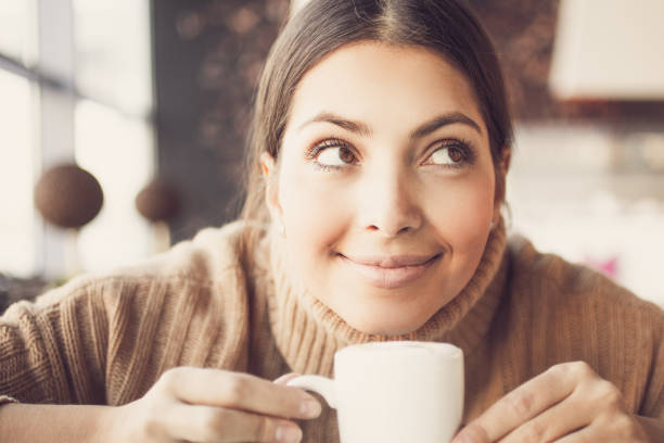 istock Dreamful funny woman with mug looking up_tone 826599578