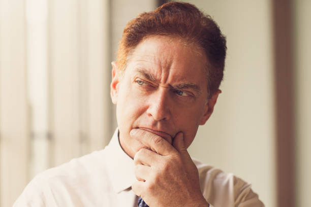 istock Reflective male CEO rubbing chin when he thinking_tone 826600650