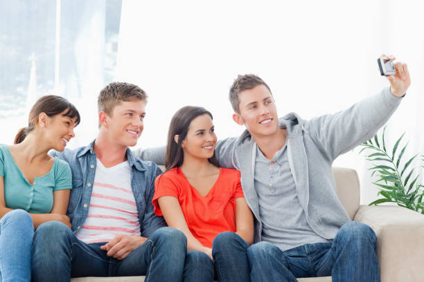istock A group of friends pose for a photo while on the couch 826608670