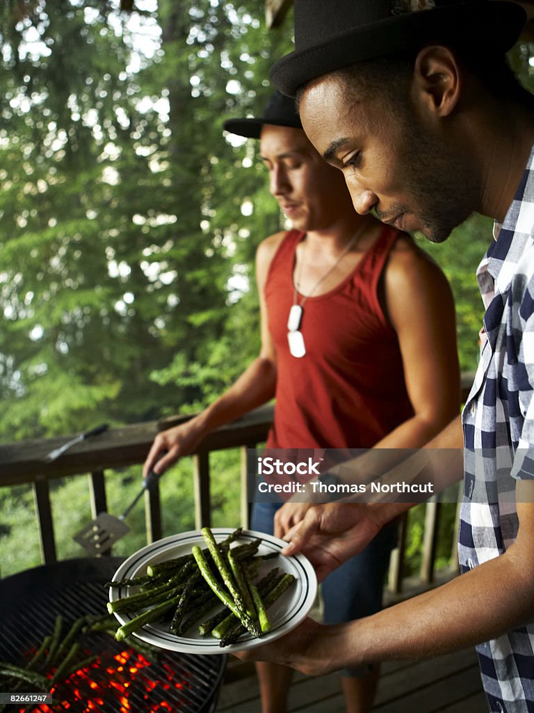 Friends grilling asparagus  Cooking Stock Photo