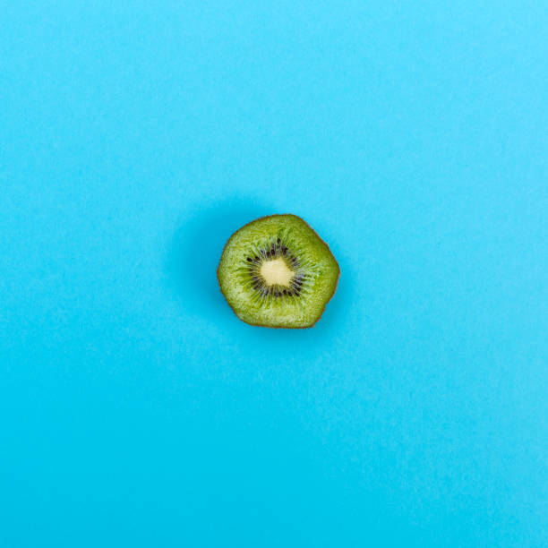 istock Slice of kiwi on a blue background 826612974
