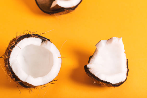 istock Fresh coconut on a yellow background 826613208