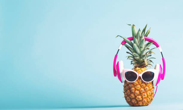 istock Pineapple with headphones and glasses 826613232