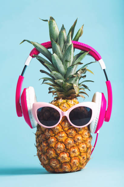 istock Pineapple with headphones and glasses 826613240