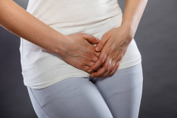 istock woman with hands holding her crotch 826614626