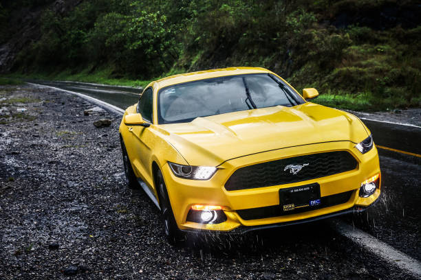 Ford Mustang OAXACA, MEXICO - MAY 24, 2017: Yellow sportcar Ford Mustang at the interurban road. charging sports photos stock pictures, royalty-free photos & images