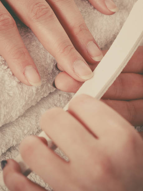 istock Woman getting manicure done file nails 826618822