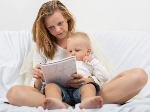 istock Young mother is drawing with her son indoors 826621330