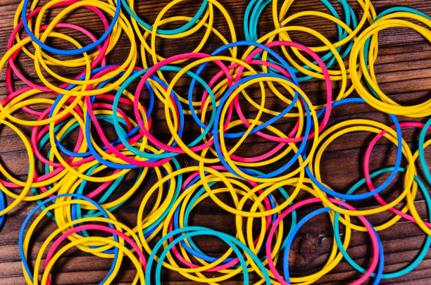 istock Multicolored rubber bands on wooden table. Top view 826622474